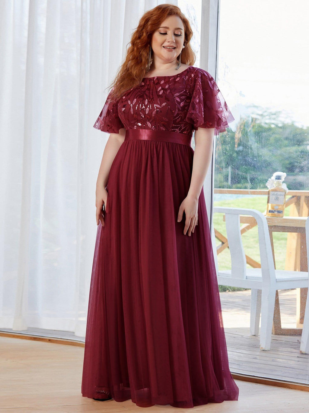 Plus size evening dress in deep blue, featuring embroidered details and elegant ruffle sleeves. Floor-length style. 16