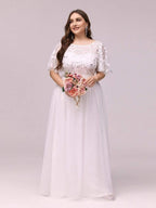 Plus size evening dress in deep blue, featuring embroidered details and elegant ruffle sleeves. Floor-length style. 17