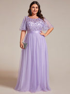 Plus size evening dress in deep blue, featuring embroidered details and elegant ruffle sleeves. Floor-length style. 18
