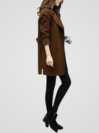 Longline double-breasted coat for women with wide notched lapels.