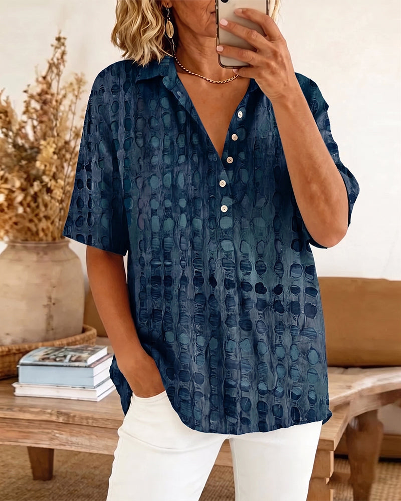 Short sleeve blouse in white with black polka dots, featuring a relaxed fit and elegant collar style. 10