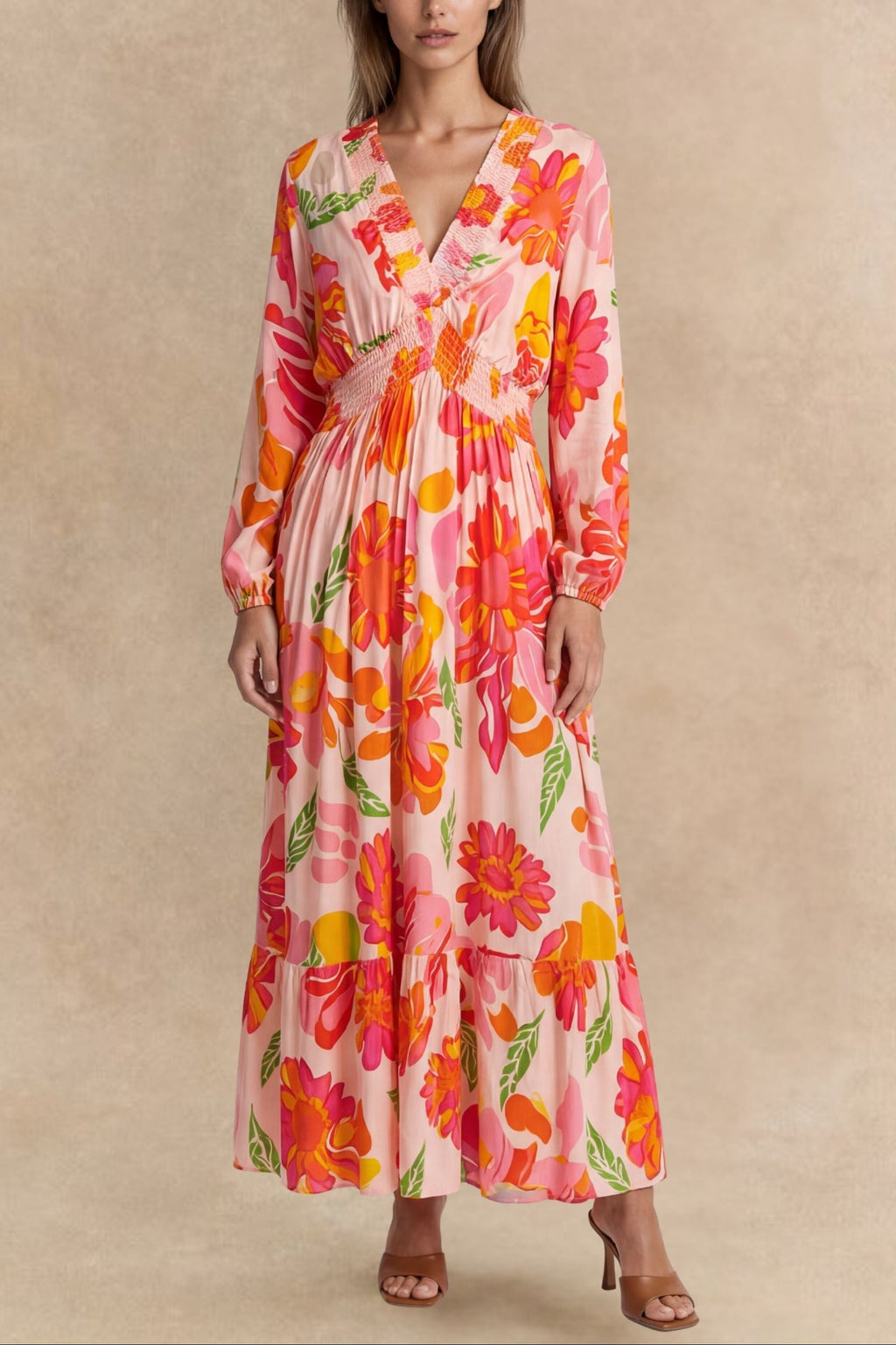 Flowy pink floral maxi dress with a V-neckline and long sleeves, featuring a smocked bodice for a relaxed fit. 0