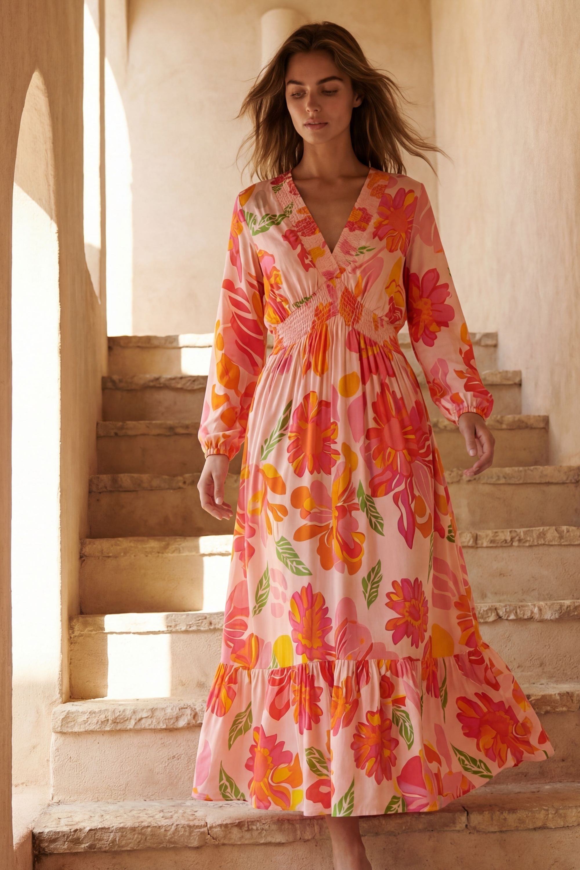Flowy pink floral maxi dress with a V-neckline and long sleeves, featuring a smocked bodice for a relaxed fit. 3