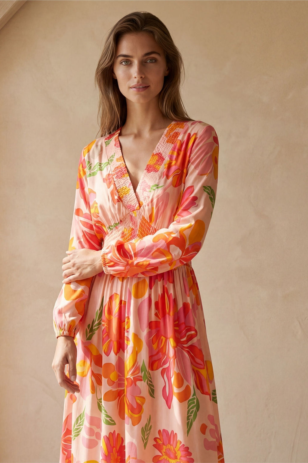 Flowy pink floral maxi dress with a V-neckline and long sleeves, featuring a smocked bodice for a relaxed fit. 4