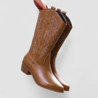 Women's orthopedic leather-look mid-calf western boots with tonal flame stitching.