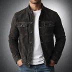 Tailored navy suede jacket with a structured fit and flap pockets. 3