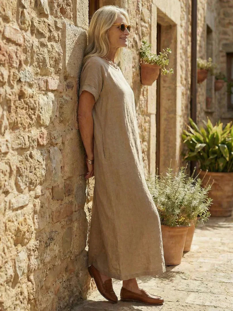 White midi linen day dress with a round neckline and simple style. 1