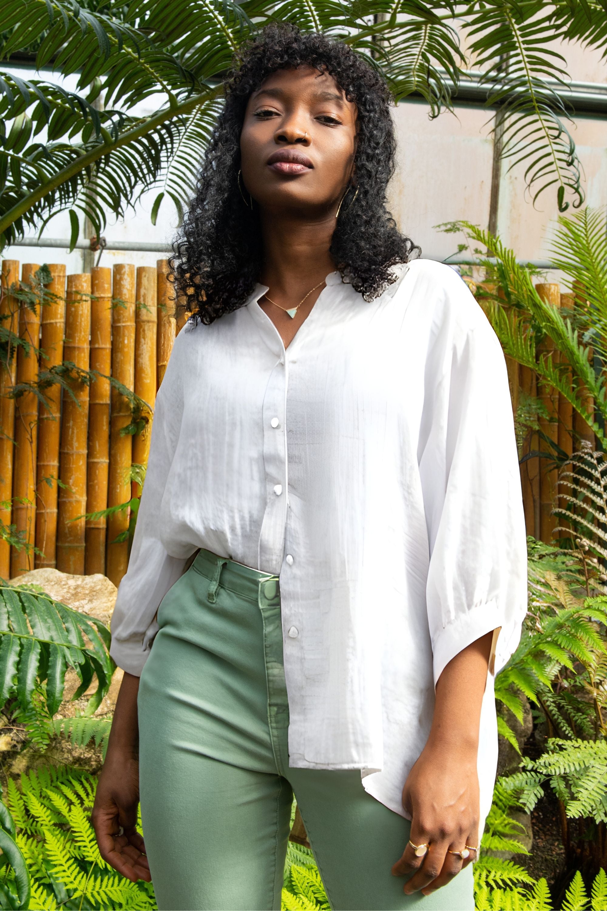 Oversized semi-sheer white shirt in a cotton blend, featuring a relaxed fit and a V-neckline. 2