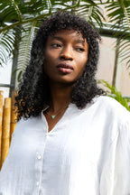 Oversized semi-sheer white shirt in a cotton blend, featuring a relaxed fit and a V-neckline. 3