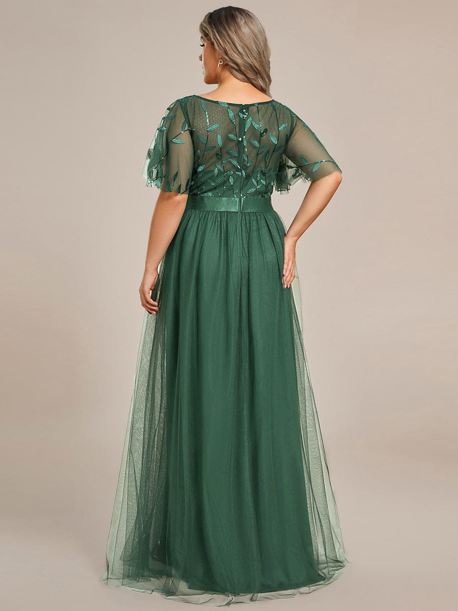 Plus size gown with a sequinned leaf bodice, satin waistband and full tulle skirt.