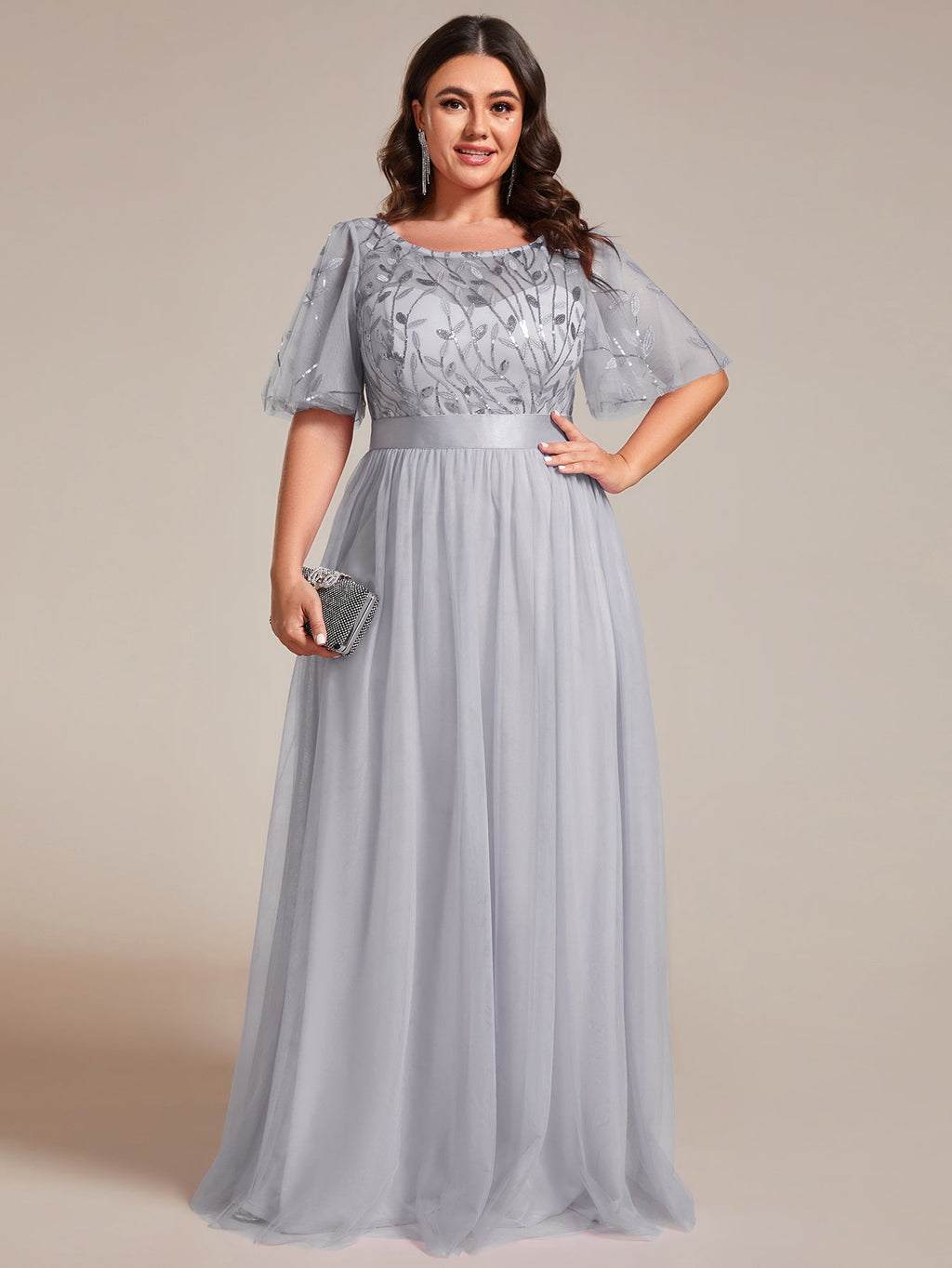 Plus size gown with a sequinned leaf bodice, satin waistband and full tulle skirt.