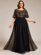 Plus size gown with a sequinned leaf bodice, satin waistband and full tulle skirt.