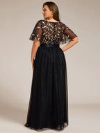 Plus size gown with a sequinned leaf bodice, satin waistband and full tulle skirt.