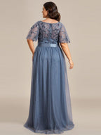 Plus size gown with a sequinned leaf bodice, satin waistband and full tulle skirt.
