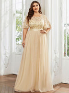 Plus size gown with a sequinned leaf bodice, satin waistband and full tulle skirt.