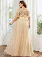 Plus size gown with a sequinned leaf bodice, satin waistband and full tulle skirt.