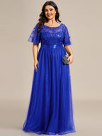 Royal blue plus size gown with a sequinned leaf bodice, satin waistband and tulle skirt.