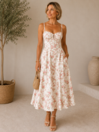 Floral print midi dress in soft pastel colors with a fitted bustier bodice, featuring a flowing skirt. 1