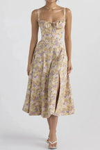 Floral print midi dress in soft pastel colors with a fitted bustier bodice, featuring a flowing skirt. 2