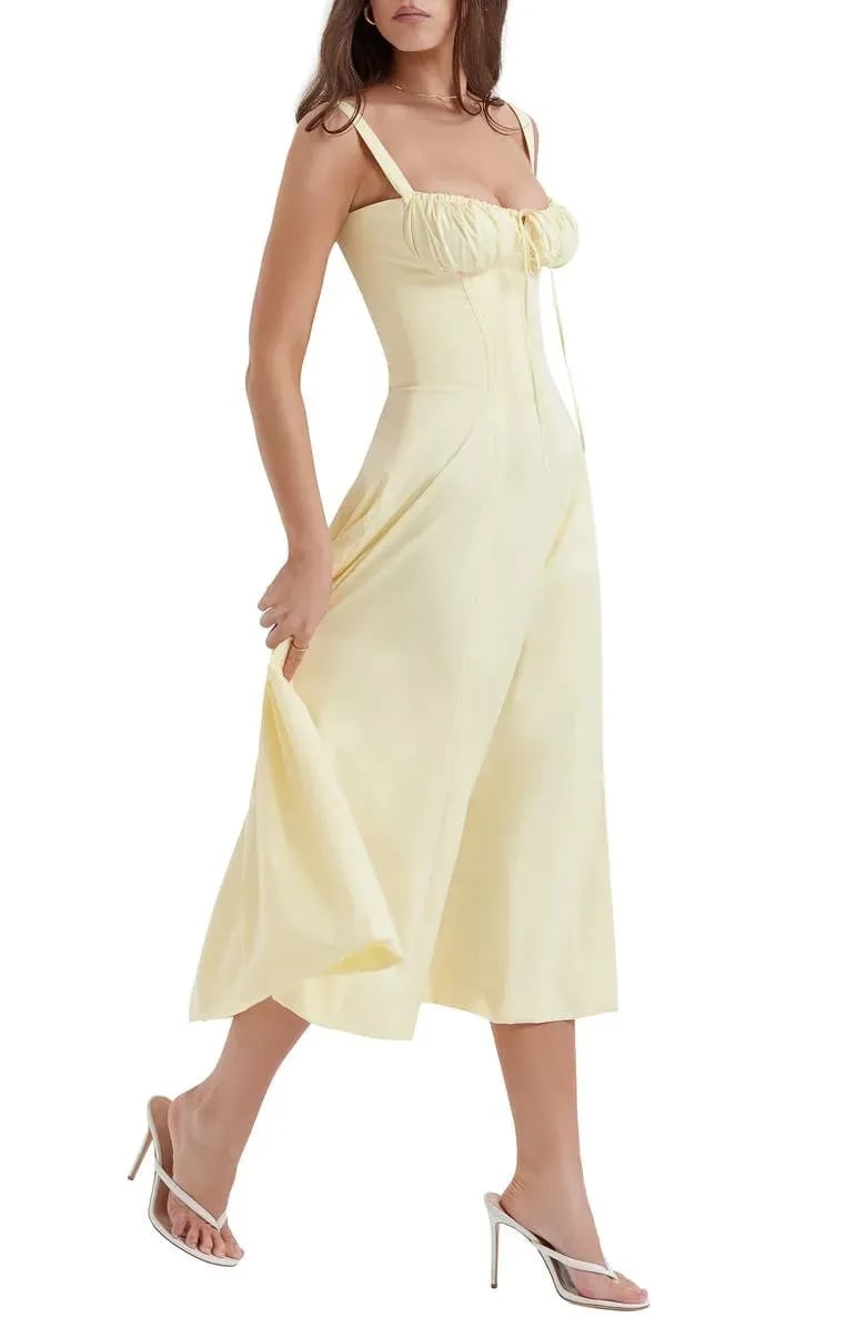 Floral print midi dress in soft pastel colors with a fitted bustier bodice, featuring a flowing skirt. 6