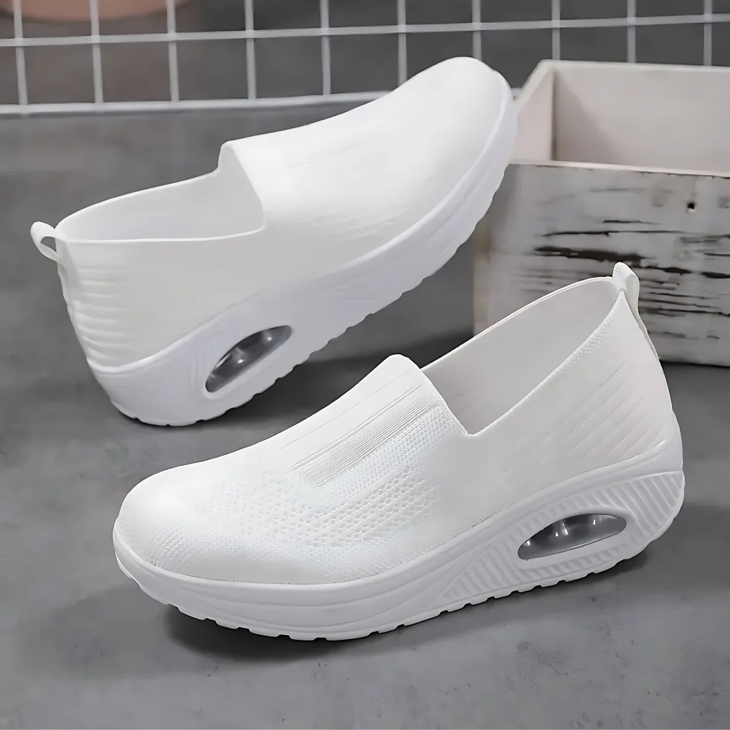 Knitted slip-on sneakers for women with a cushioned wedge sole.