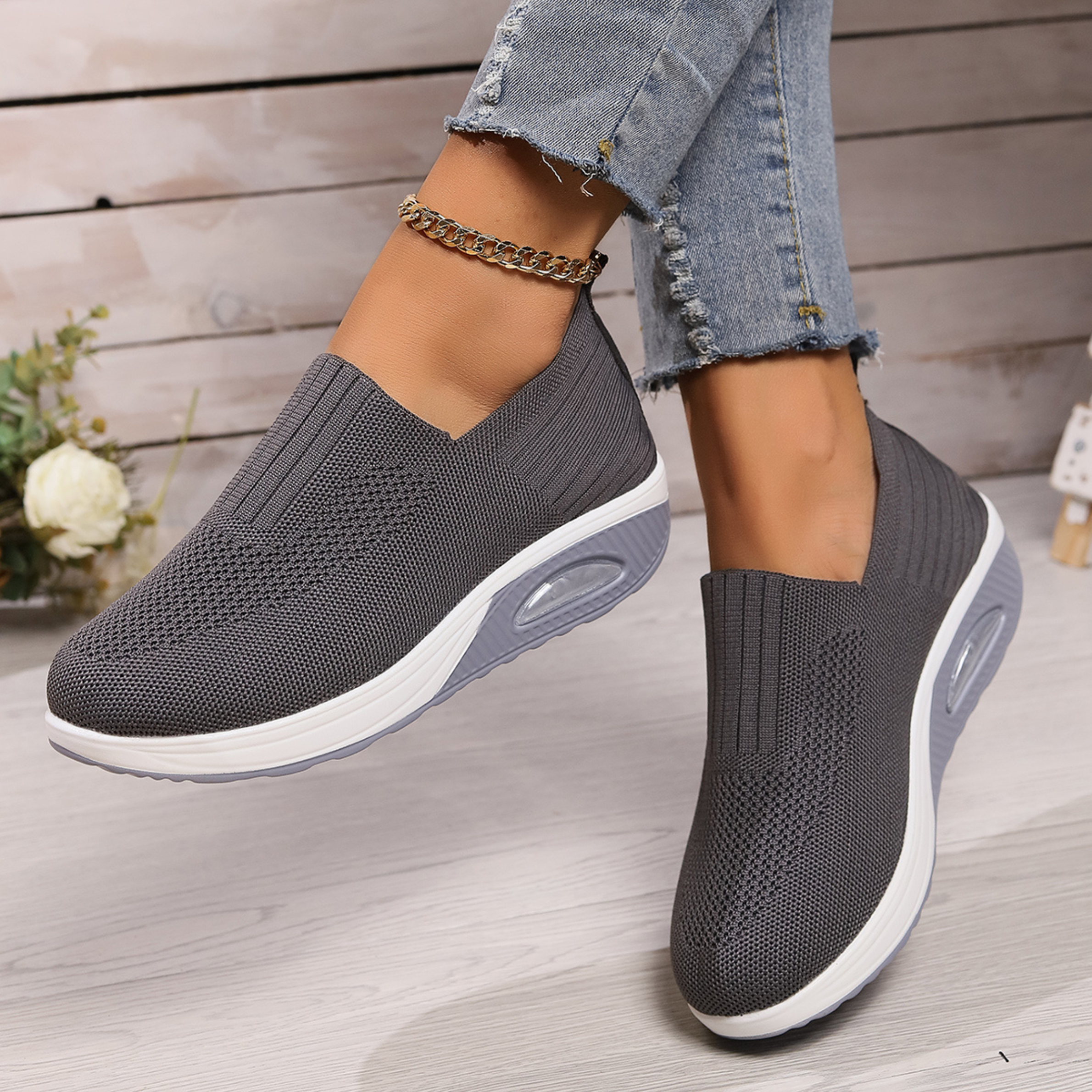 Knitted slip-on sneakers for women with a cushioned wedge sole.