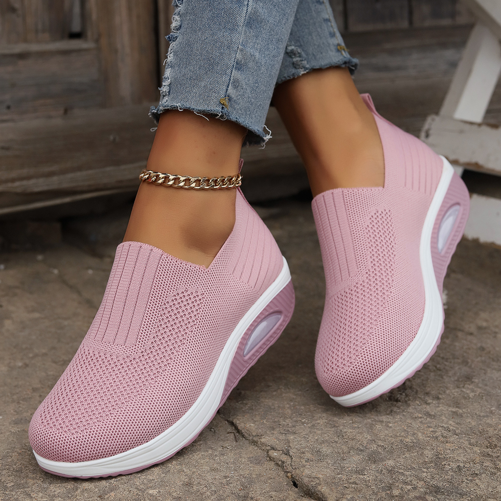 Knitted slip-on sneakers for women with a cushioned wedge sole.