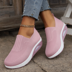 Knitted slip-on sneakers for women with a cushioned wedge sole.