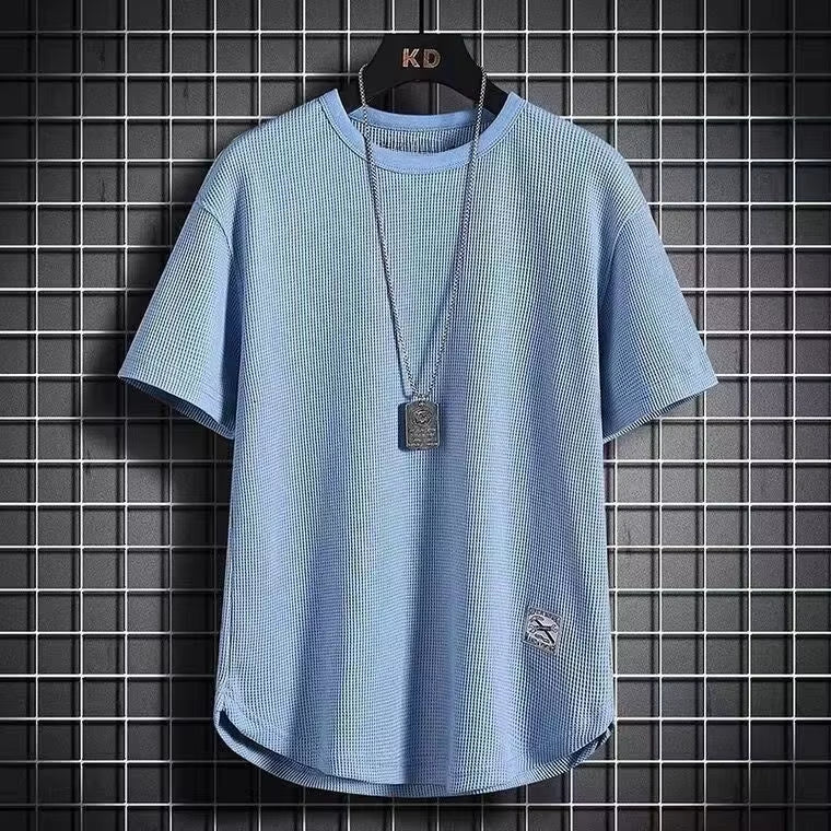 A navy blue waffle-knit men's shirt with a casual style and long sleeves. 2