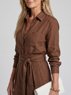 Black long-sleeve jumpsuit with a wide-leg design, offering a modern and comfortable fit for women. 1