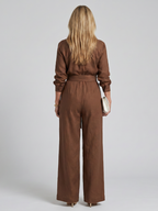 Black long-sleeve jumpsuit with a wide-leg design, offering a modern and comfortable fit for women. 3