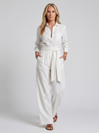 Black long-sleeve jumpsuit with a wide-leg design, offering a modern and comfortable fit for women. 4