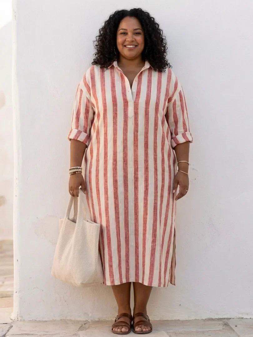 A striped midi shirt dress in navy blue with buttons down the front and long sleeves. 4