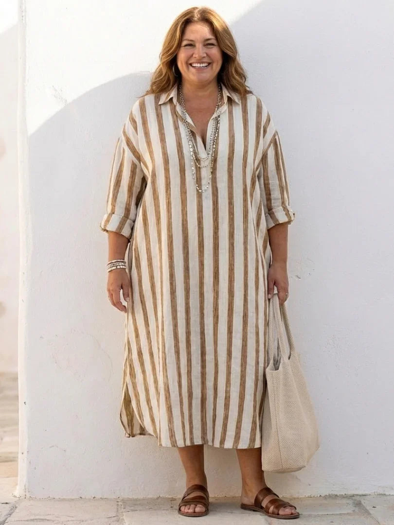 A striped midi shirt dress in navy blue with buttons down the front and long sleeves. 7