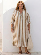 A striped midi shirt dress in navy blue with buttons down the front and long sleeves. 7