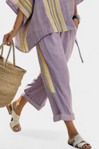 Lavender top paired with mustard striped oversized pants, creating a relaxed and chic casual outfit for women. 3