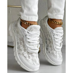 Stylish white sneakers with a minimalist design, perfect for everyday wear. 0