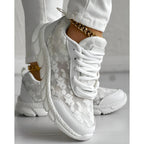 Stylish white sneakers with a minimalist design, perfect for everyday wear. 3