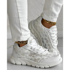Stylish white sneakers with a minimalist design, perfect for everyday wear. 4