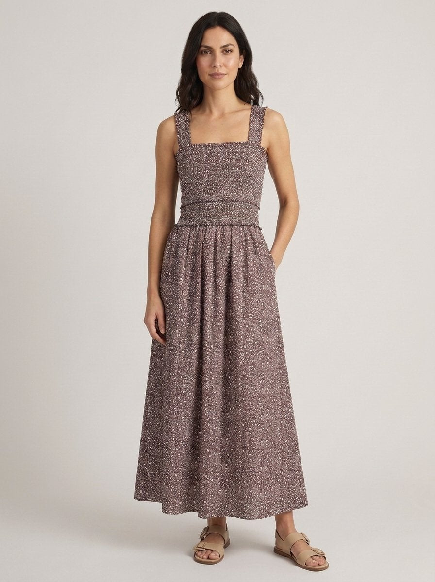 Chocolate ditsy floral smocked maxi dress, hands in pockets pose