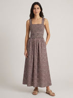 Chocolate ditsy floral smocked maxi dress, hands in pockets pose