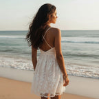 A sleeveless white lace summer dress with an A-line silhouette, featuring delicate floral patterns and a flowing design. 1