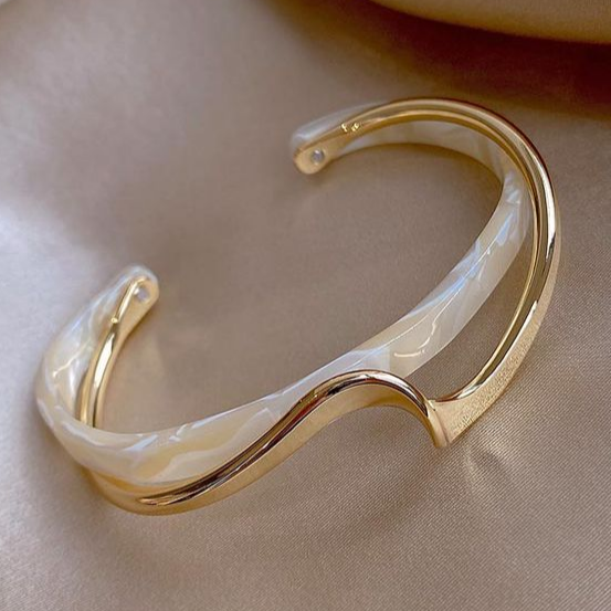 Opale gold-tone wave cuff bracelet with an ivory inlay